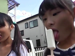Tiny japanese schoolgirl eating popsicle
