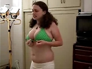 Obese non-specific tries on the top of bikini